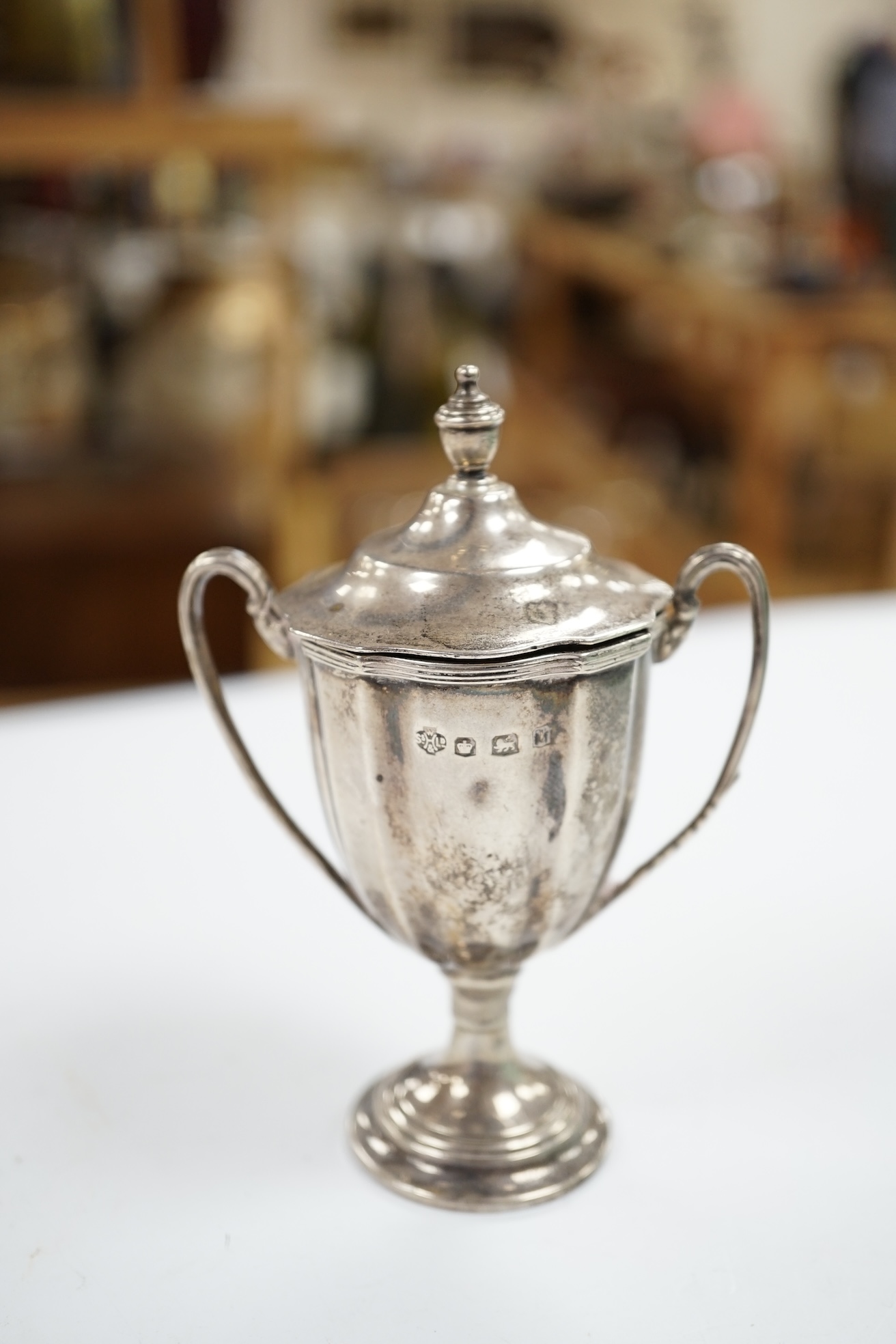 A collection of small silver collectables including a mounted hip flask, five napkin rings, two mounted toilet jars, trinket box, two wine labels, three condiments, a silver collar and a small trophy cup. Condition - poo